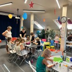 Powiększ zdjęcie Dzieci na warsztatach w bibliotece wykonują pracę plastyczną