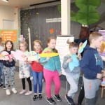 Powiększ zdjęcie Uczestnicy projektu stoją w kolejce z kapeluszami